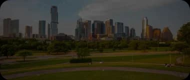Austin city skyline with a green park and warm sunlight.