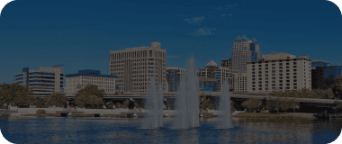 Fountains in front of a waterfront cityscape in Fort Myers.