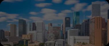 Modern skyline of Houston with a backdrop of bright clouds