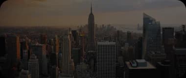 Iconic Manhattan skyline with Empire State Building at dusk.