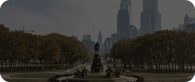 Philadelphia skyline with historic buildings and the tree-filled Parkway.
