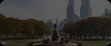 Philadelphia skyline with historic buildings and the tree-filled Parkway.