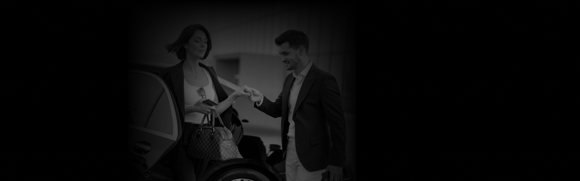 A well-dressed man is greeting a stylish woman beside a black luxury car, symbolizing professional Partnership Opportunities from a side-view angle.